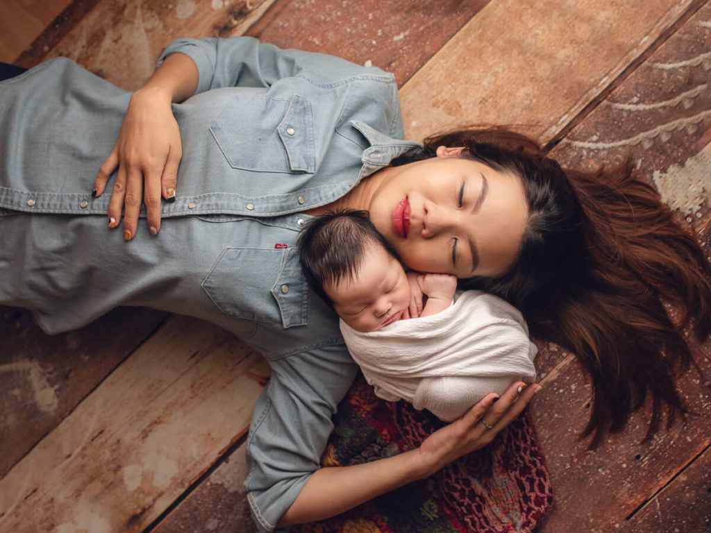 Mother and baby relaxing at newborn baby photoshoot